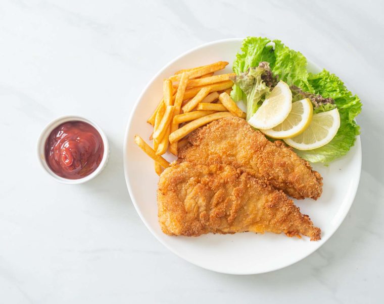 Homemade Breaded Weiner Schnitzel with Potato Chips - Fried Chicken with french fries - European food style